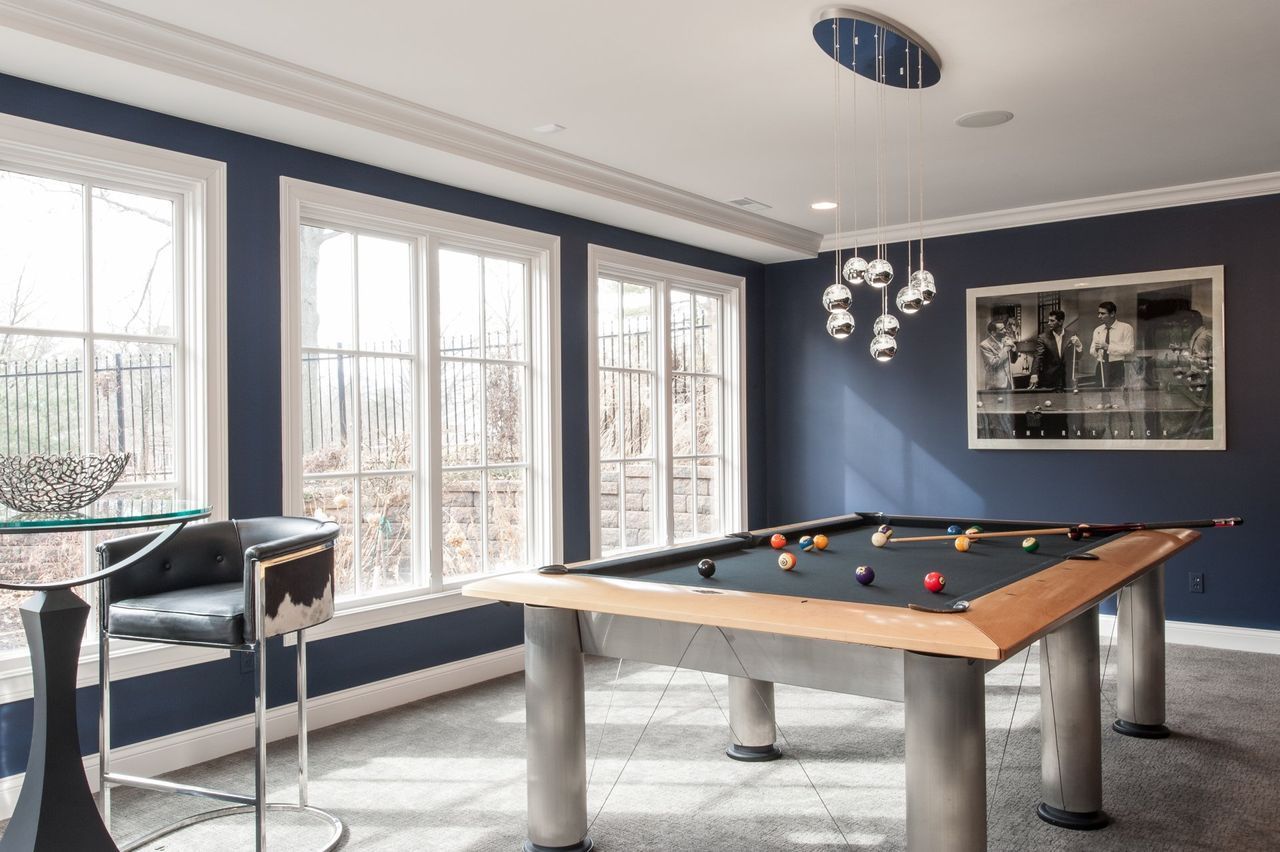 There is a pool table in the middle of the room.