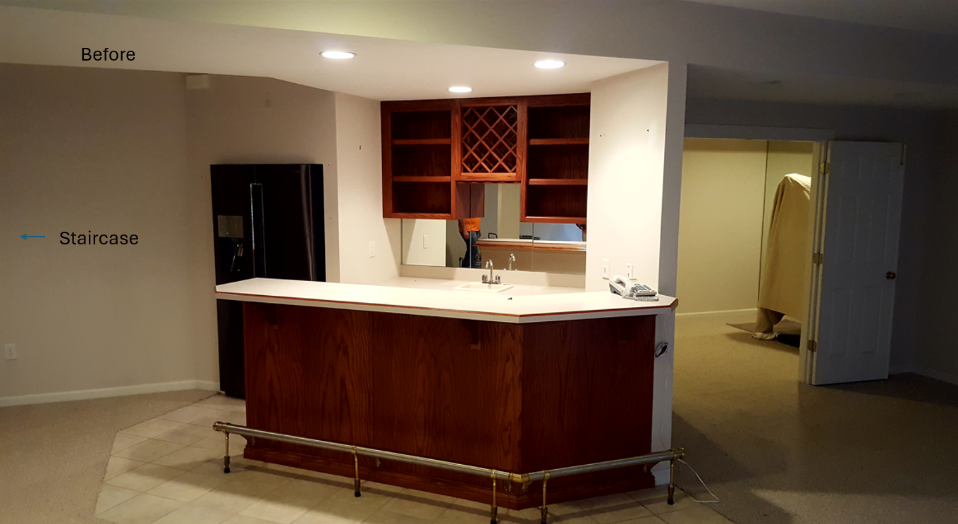 An empty room with a bar and a refrigerator
