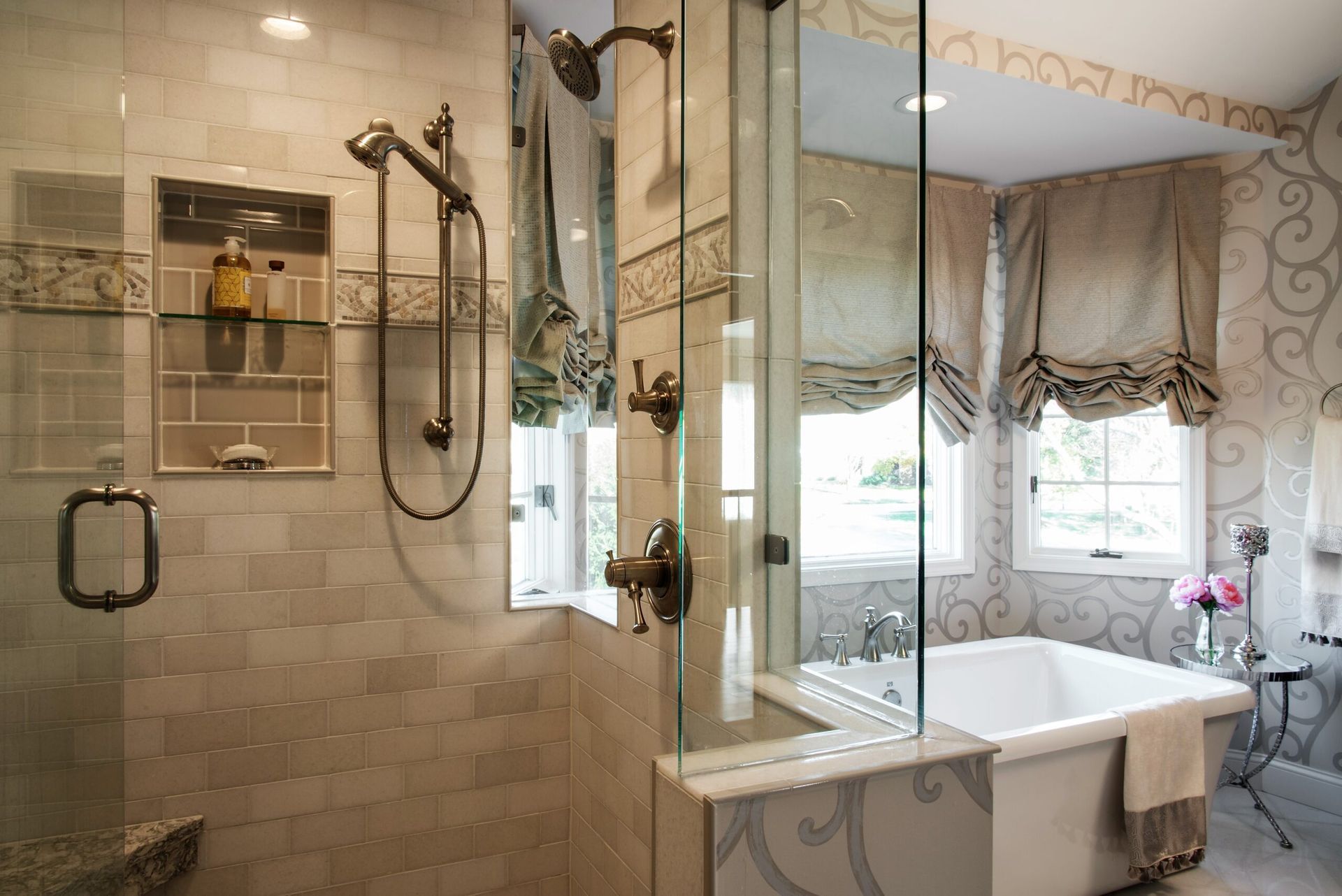 A bathroom with a tub , shower , and mirror.