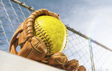 Baseball player sliding into home plate, catcher in front. Blue and gold uniforms, action shot.