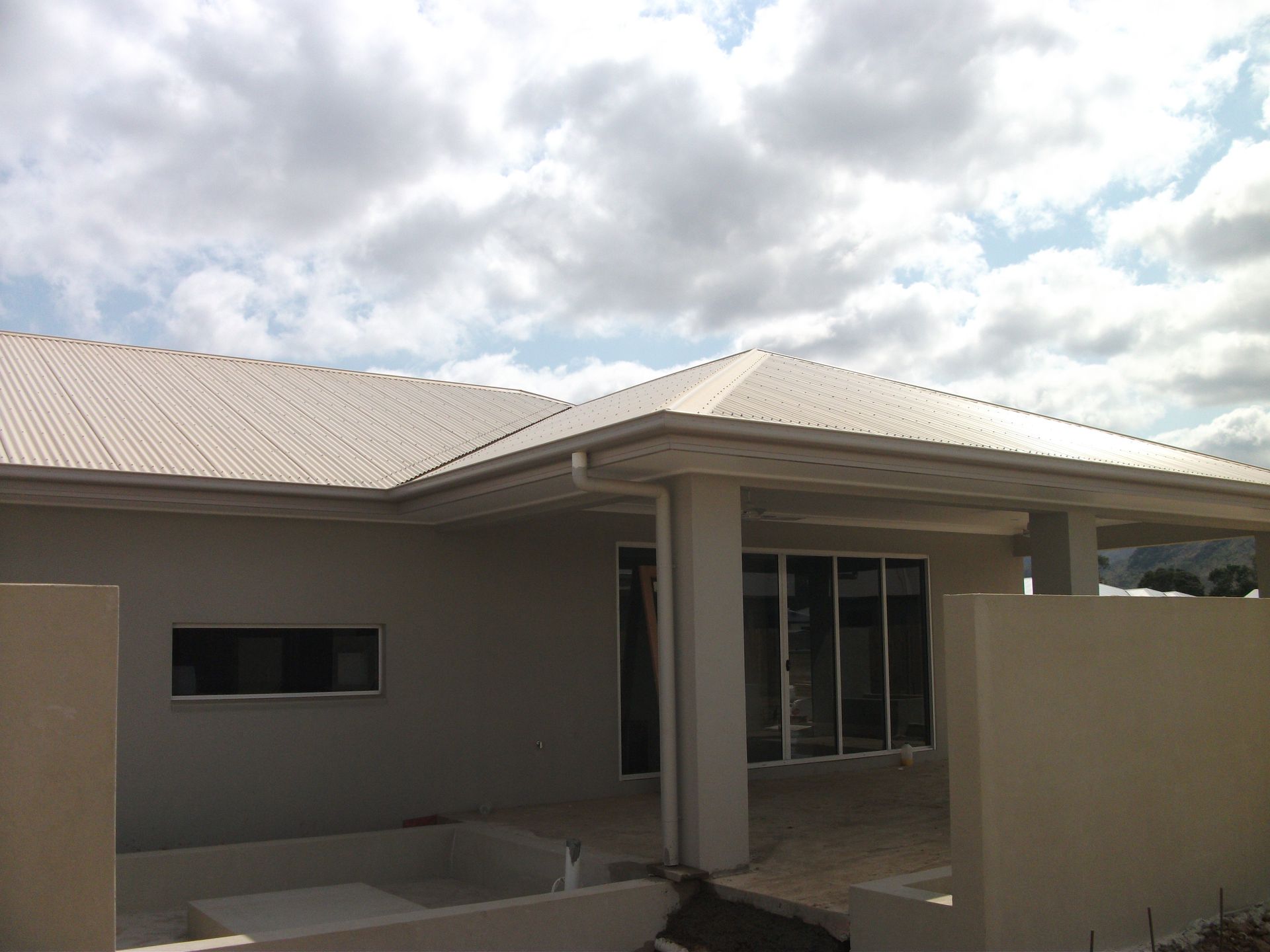 White metal roof with mountains in the background.— Roof 4 U in Rasmussen, QLD
