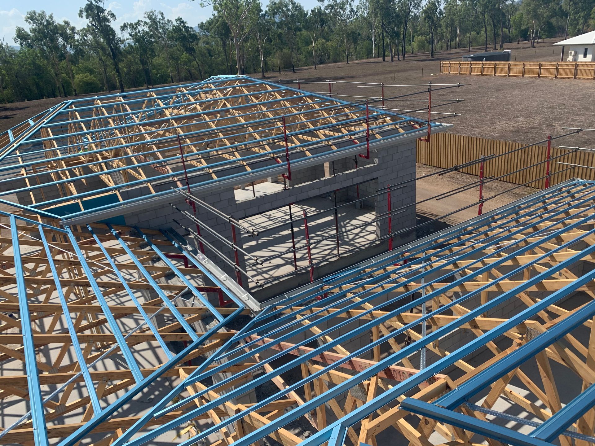 A Worker Installing Insulation on a Roof, Wearing Safety Gear — Roof 4 U in Alice River, QLD