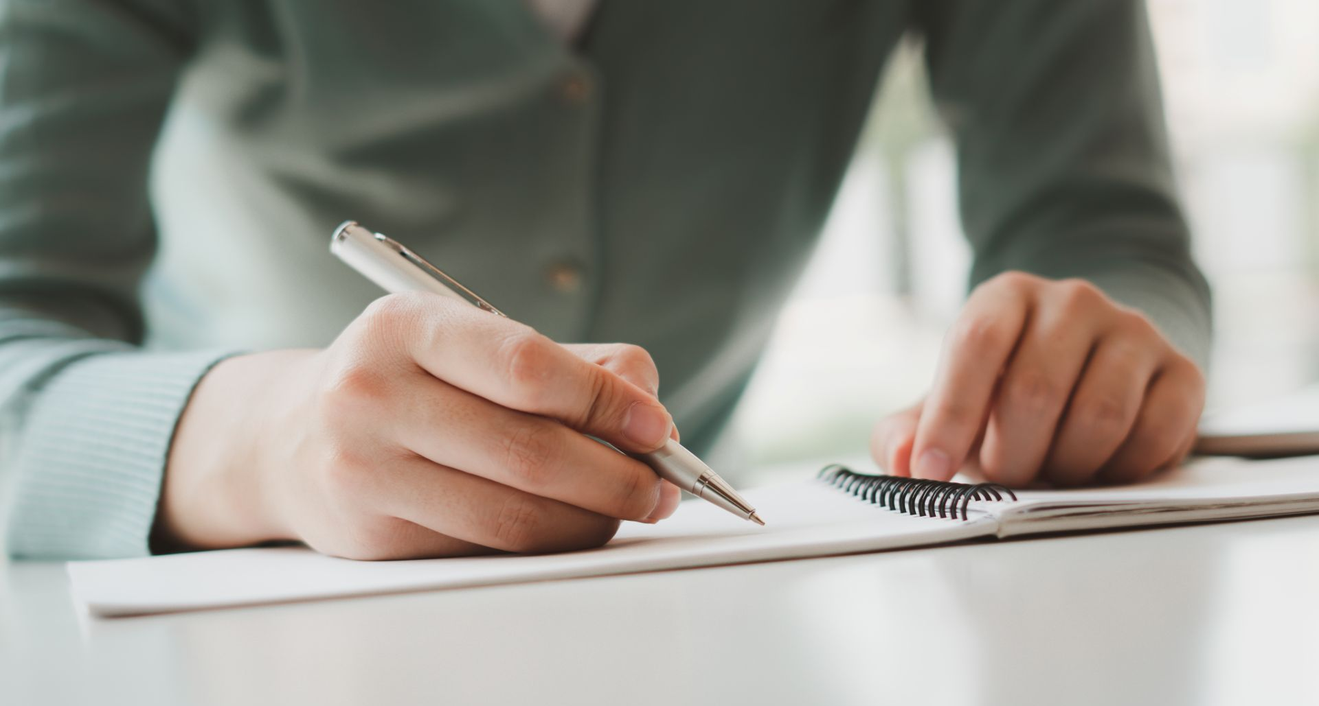 Person Writing an Obituary