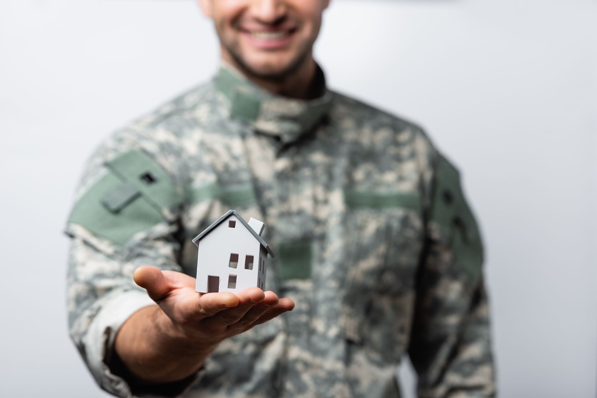 Veteran holding house in hand