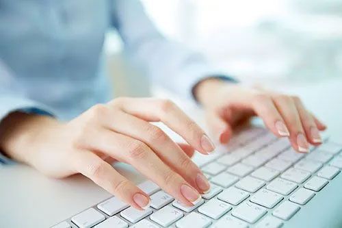 Man Typing on Keyboard at Local Life Insurance Agency