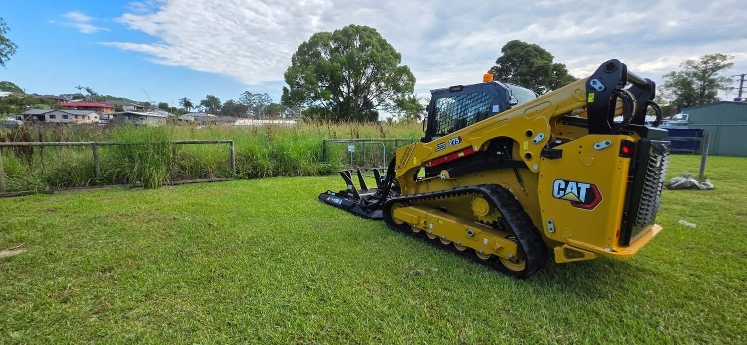 A Yellow Caterpillar Compact Track Loader Parked — Ovannah Hire In West Kempsey, NSW