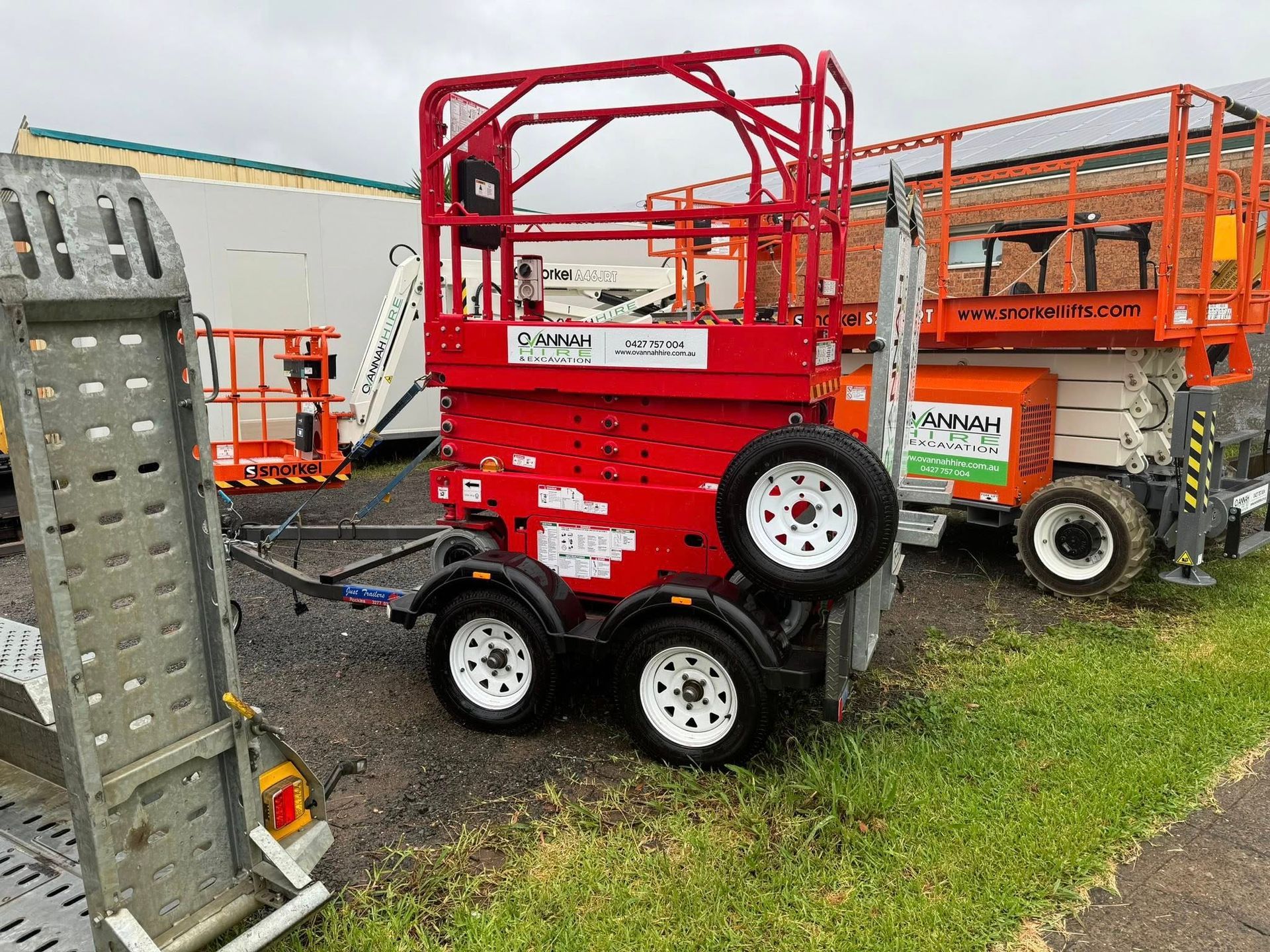 Red Aerial Lift on a Trailer, With White Tires — Ovannah Hire In West Kempsey, NSW