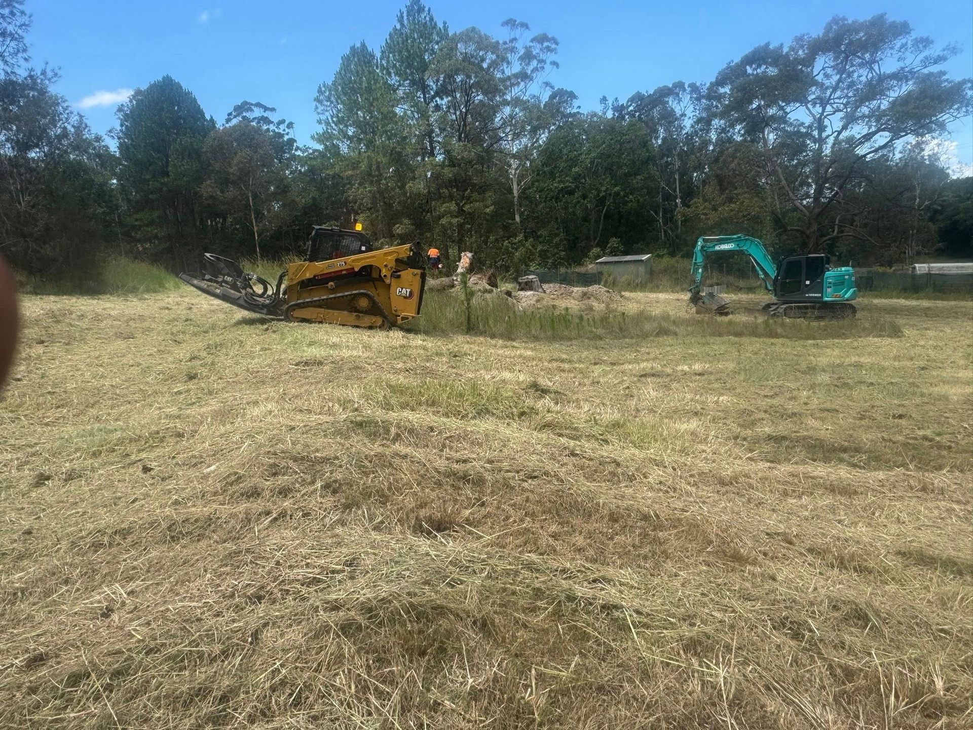 Yellow Skid Steer and Teal Excavator — Ovannah Hire In West Kempsey, NSW