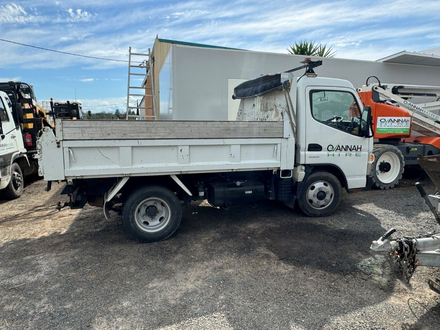 A White Dump Truck Parked on a Gravel Lot — Ovannah Hire In West Kempsey, NSW
