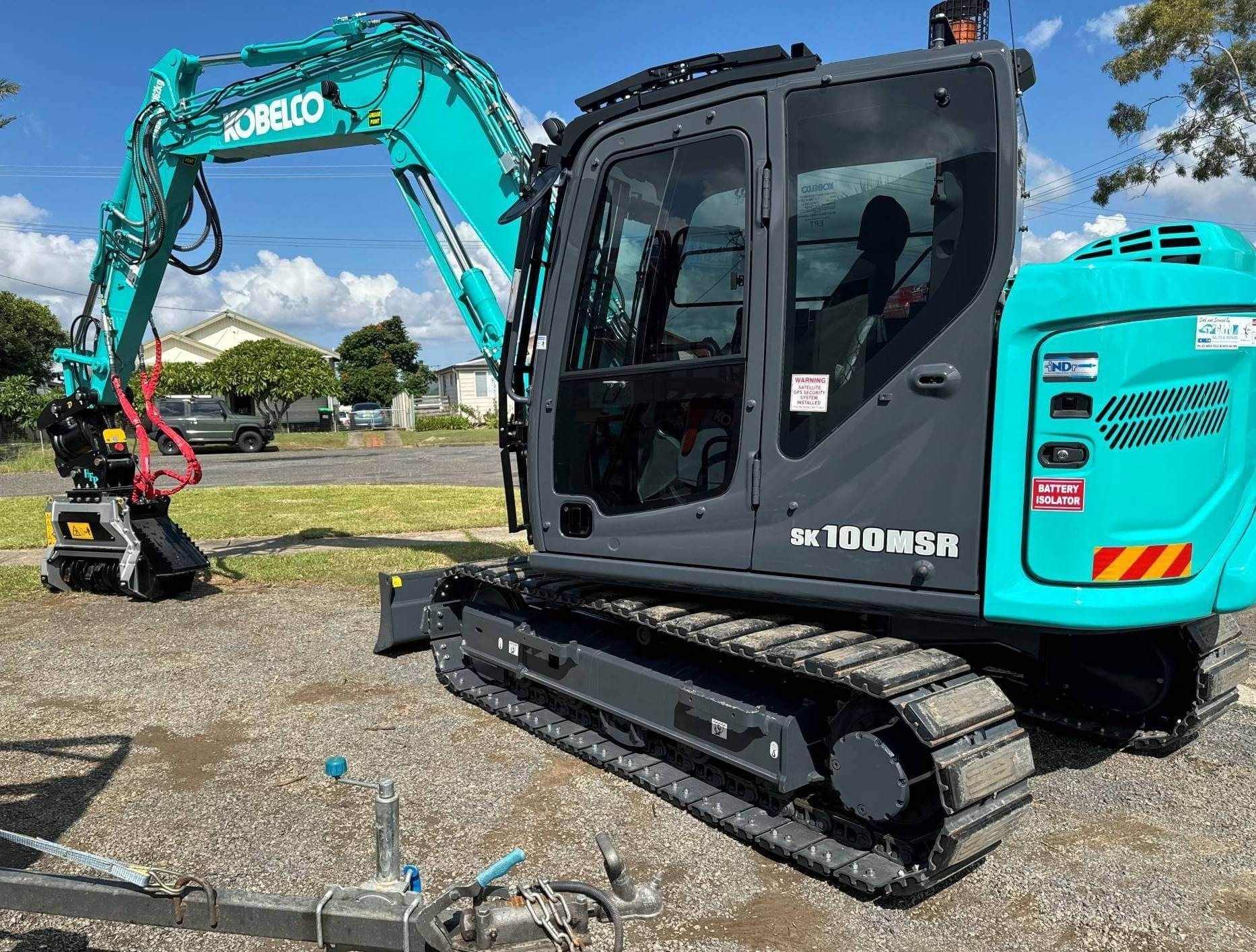 A Teal and Gray Kobelco Excavator With Tracks, Parked Outdoors — Ovannah Hire In West Kempsey, NSW