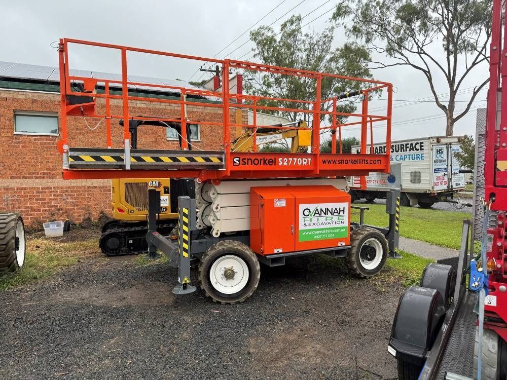Orange and White Personnel Lift With Safety Rails, Parked Outside a Building — Ovannah Hire In West Kempsey, NSW