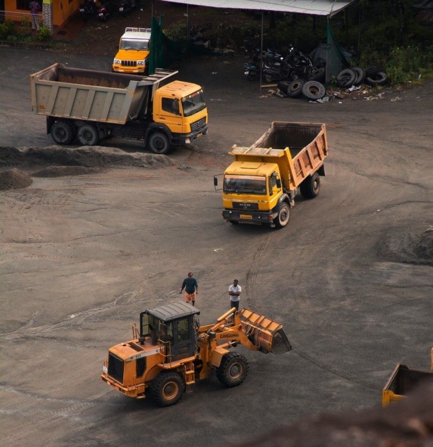 Yellow Dump Trucks and a Loader Operating at a Gravel Depot, With Workers Nearby — Ovannah Hire In West Kempsey, NSW