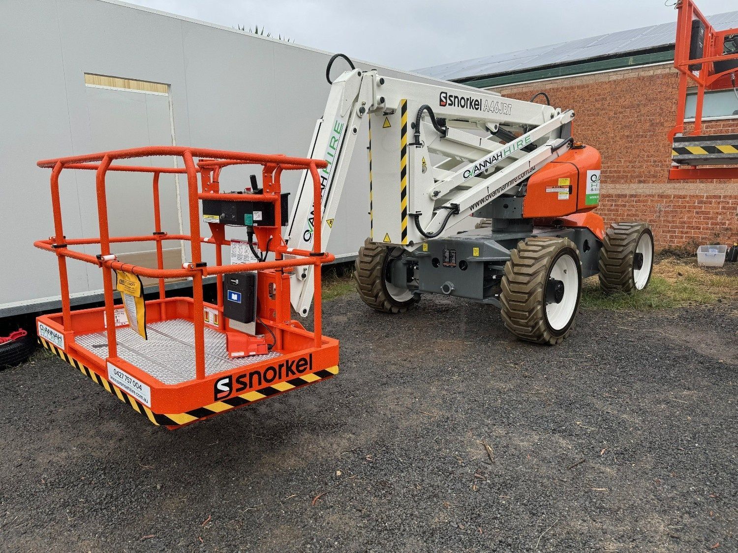 An Orange and White Snorkel Articulating Boom Lift Parked — Ovannah Hire In West Kempsey, NSW