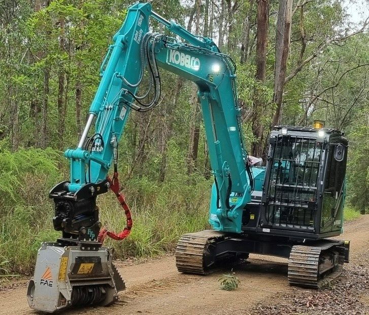 A Teal Kobelco Excavator With a Mulching Attachment — Ovannah Hire In West Kempsey, NSW