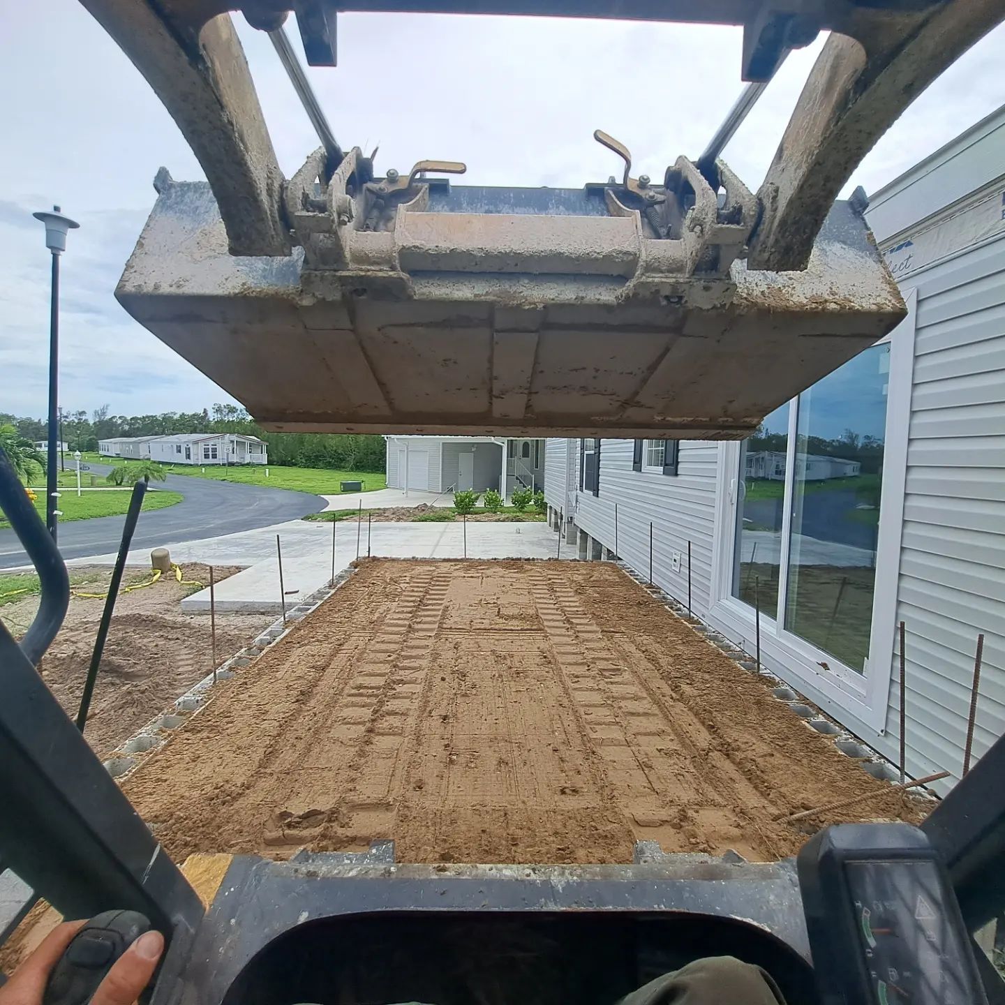 A person is driving a bulldozer on a dirt road