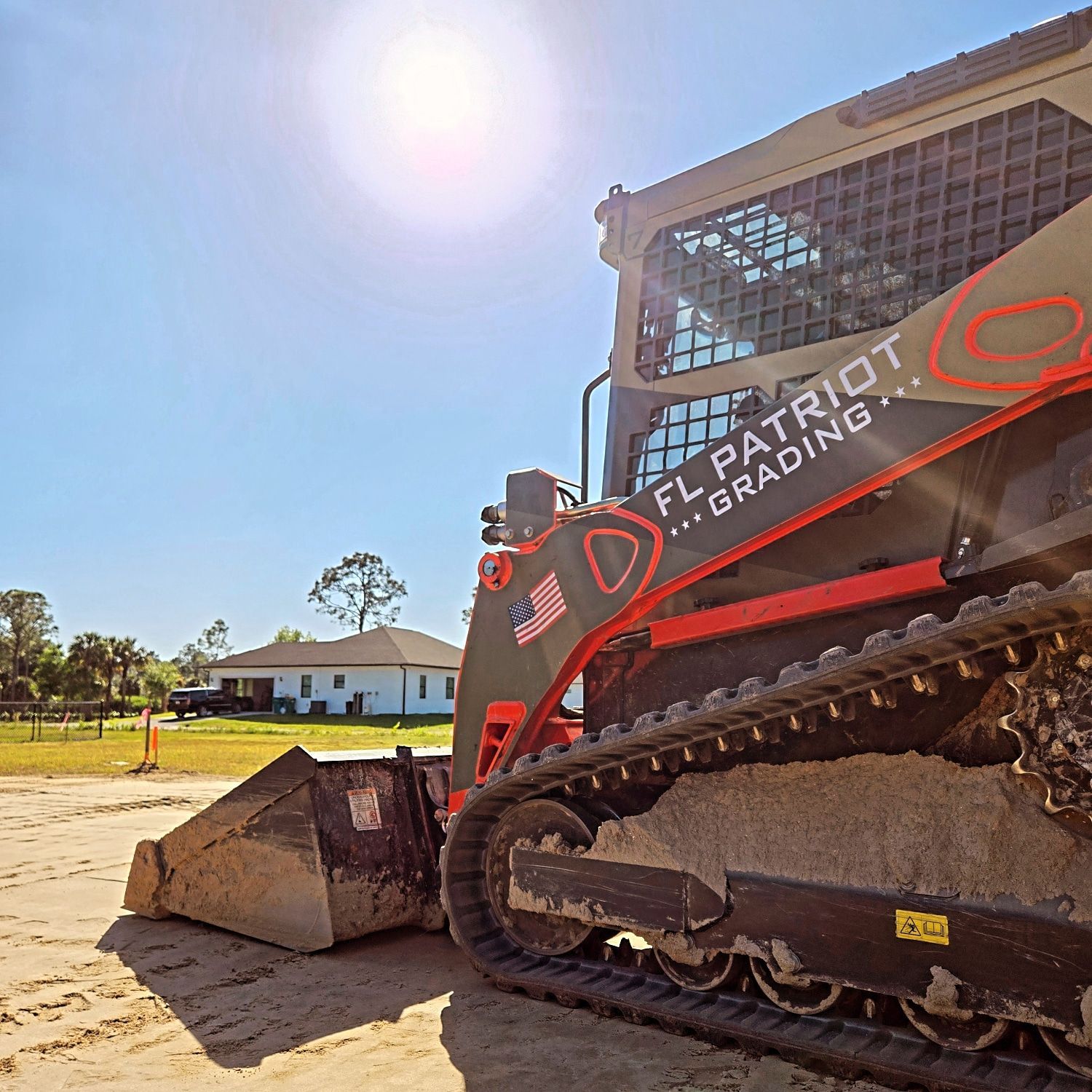 A bulldozer with the words fl patriot grading on the side