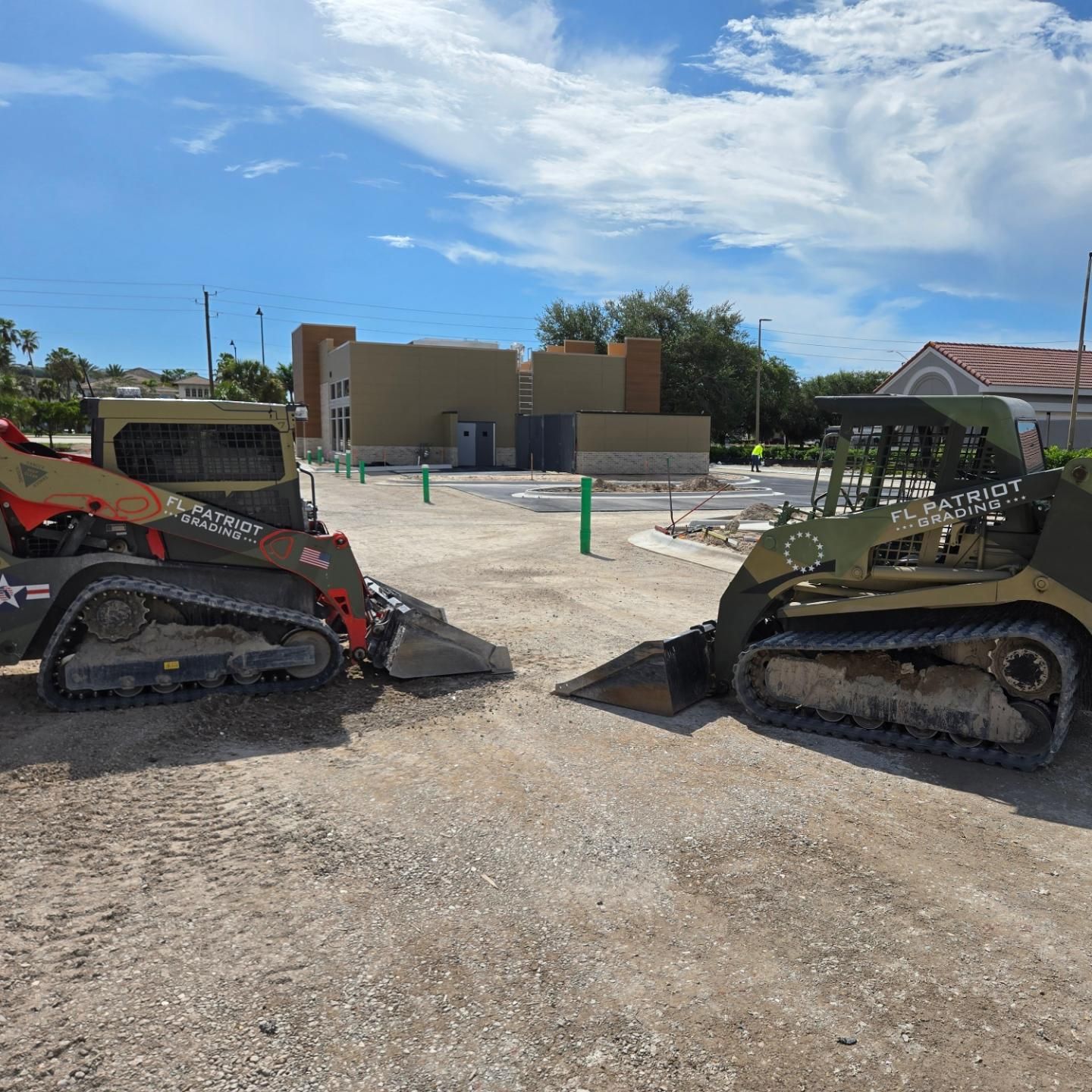 Two bulldozers are parked next to each other on a dirt road