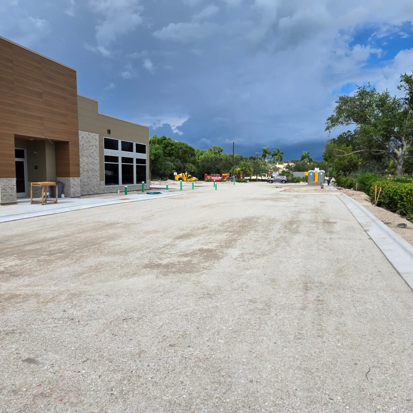 A dirt road with a building in the background