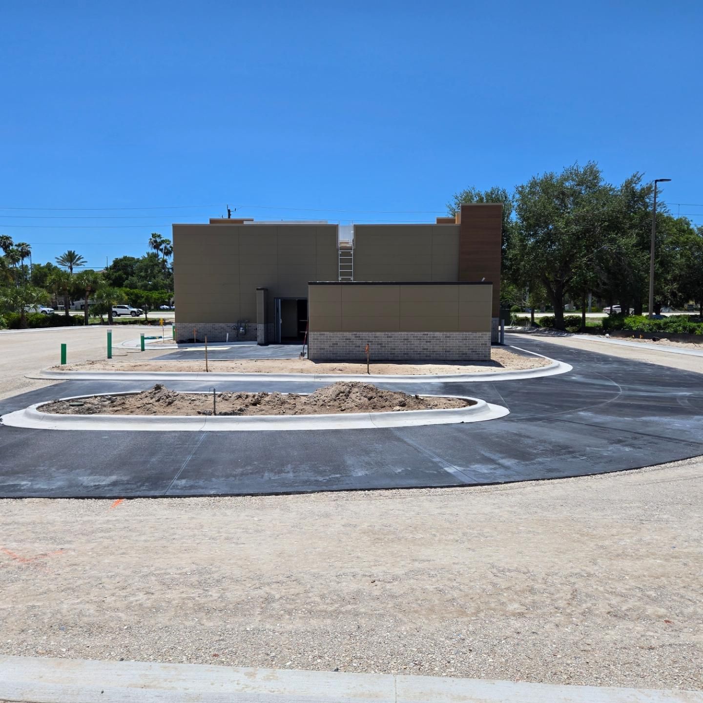 A building that is being built with a lot of dirt in front of it
