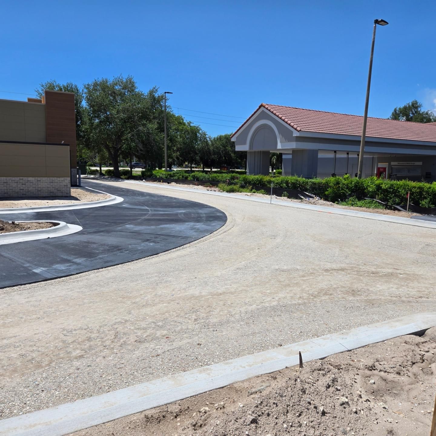 A curved road with a building in the background