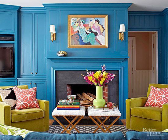 A living room with blue walls and a fireplace