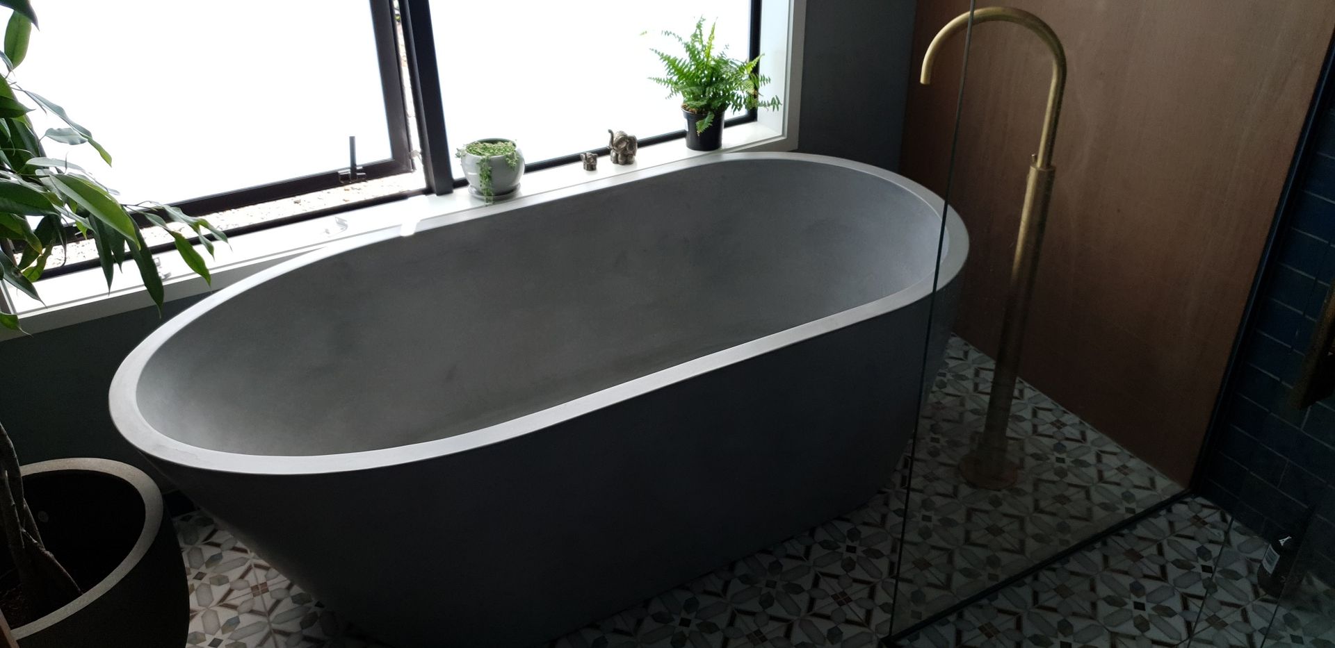 A bathtub is sitting in a bathroom next to a window.