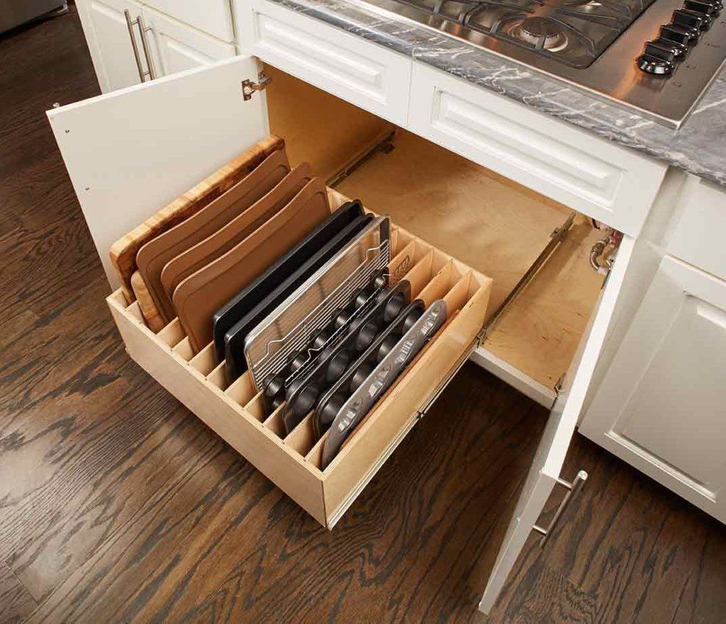 A kitchen drawer filled with cutting boards and utensils