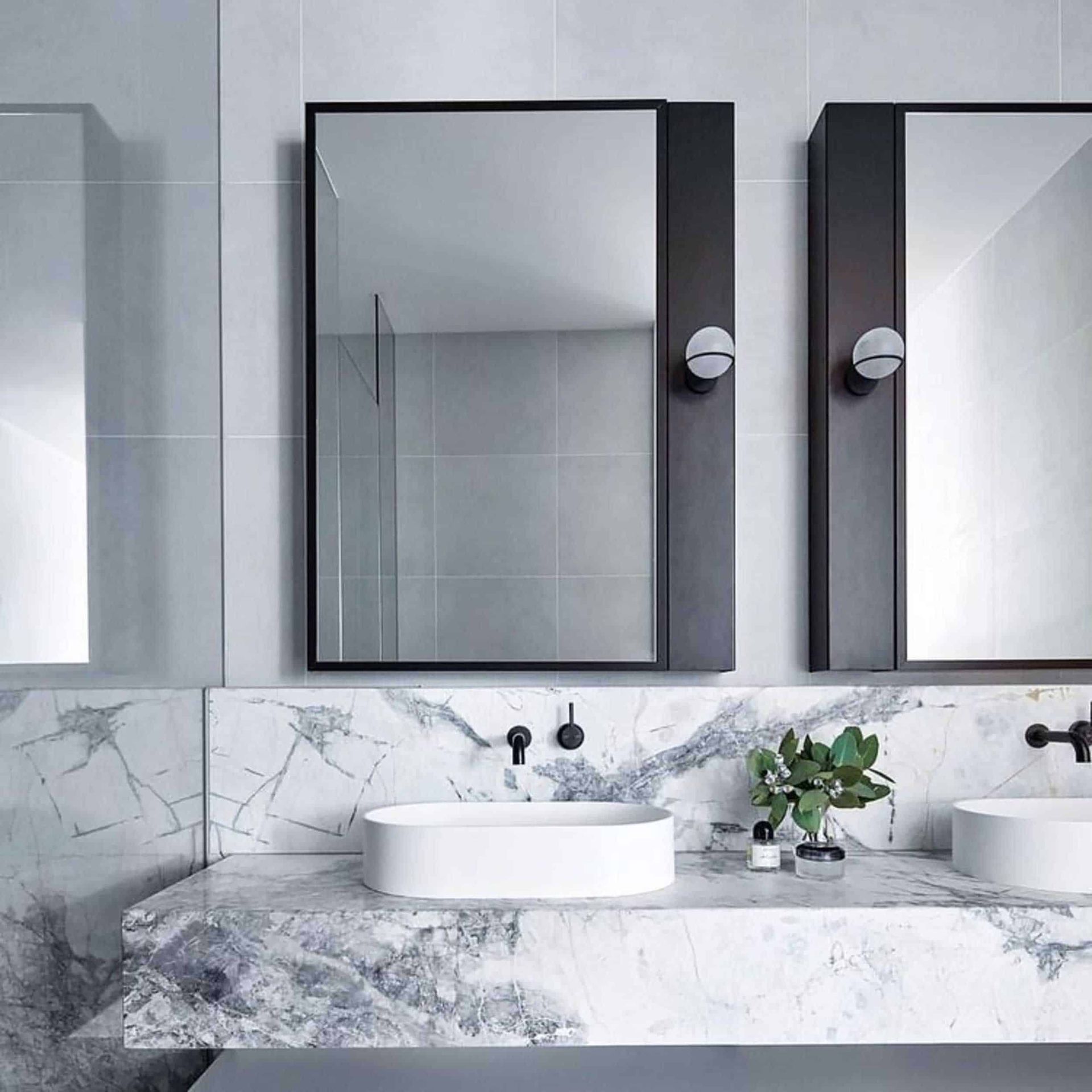 A bathroom with two sinks and two mirrors