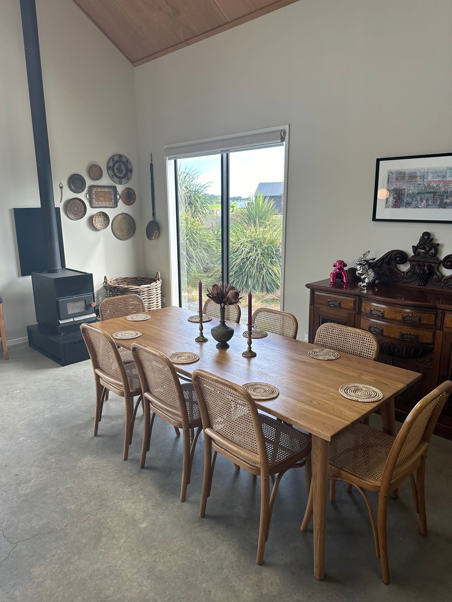 A dining room with a long wooden table and chairs