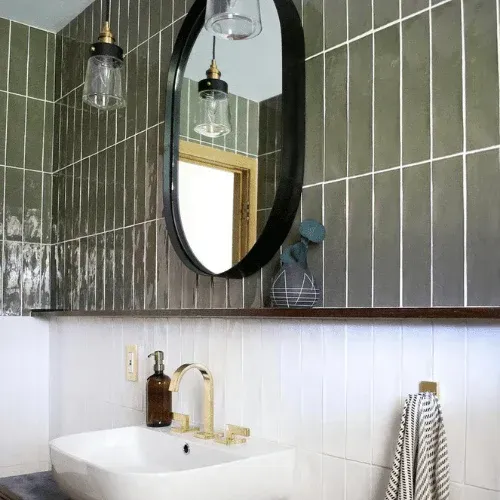 There is a sink and a mirror in the bathroom.