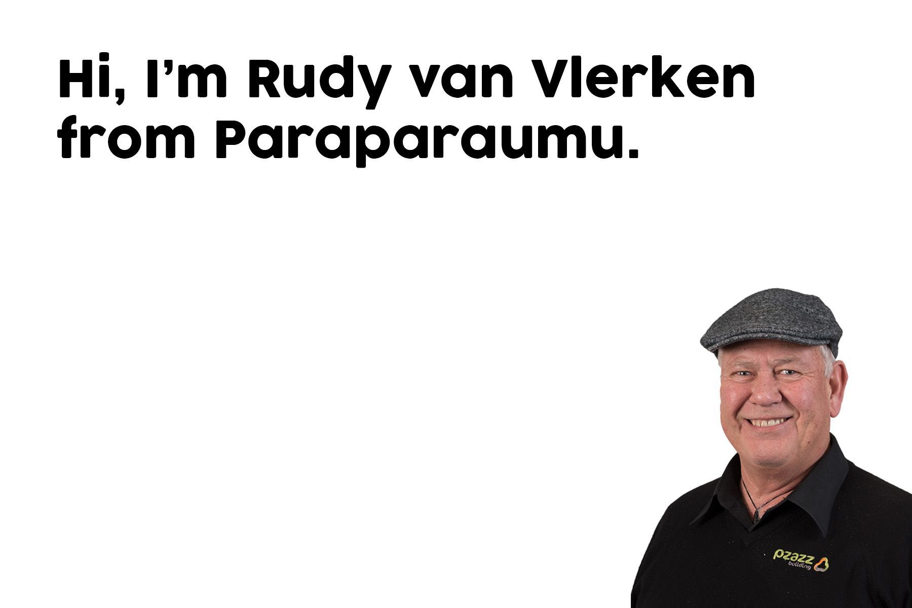 A man wearing a hat and a black shirt is standing in front of a white background.