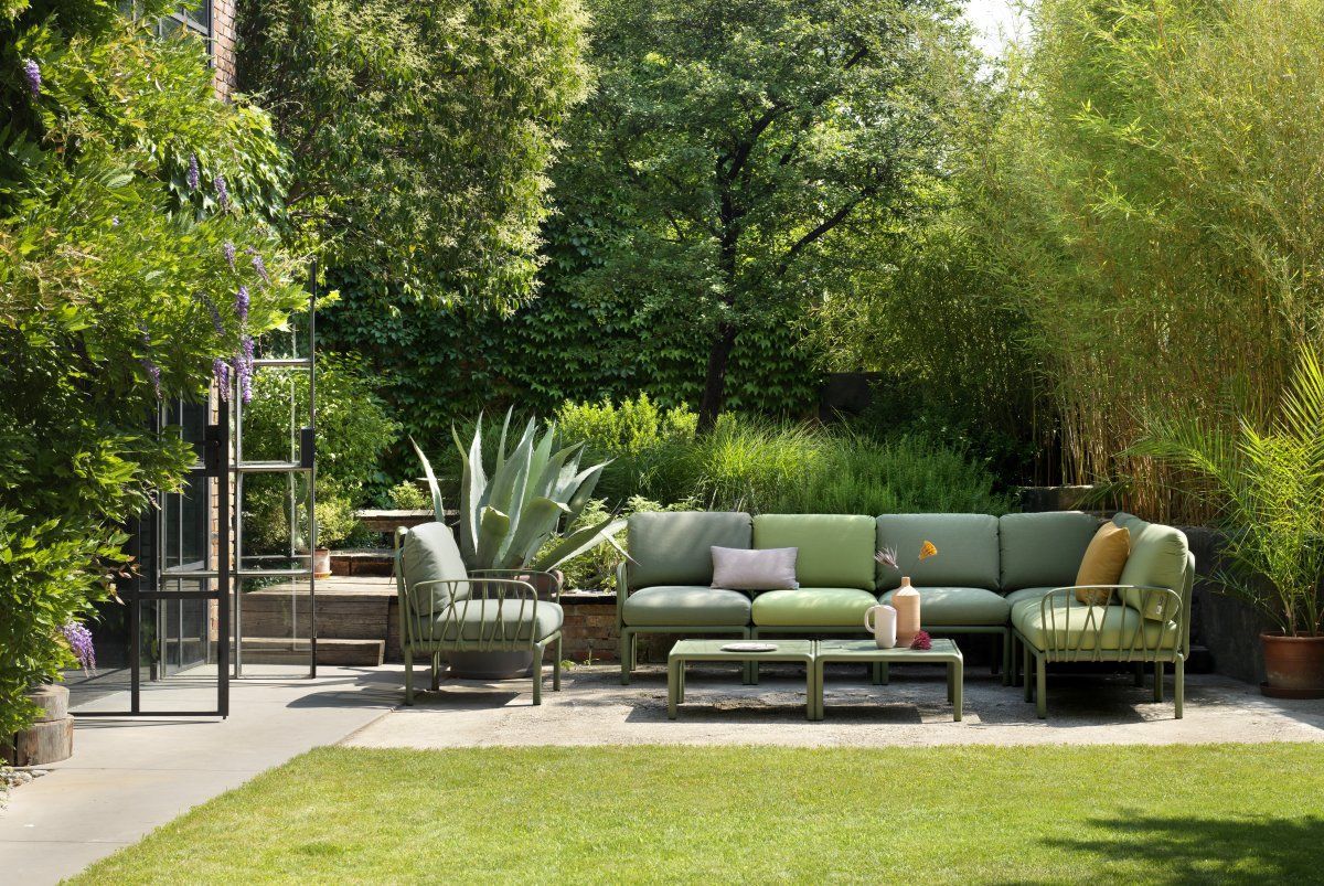 A lawn with a couch and chairs in it