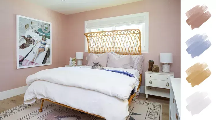 A bedroom with pink walls , a bed , nightstands , and a painting on the wall.