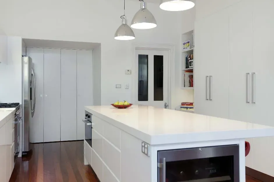 A kitchen with white cabinets and stainless steel appliances