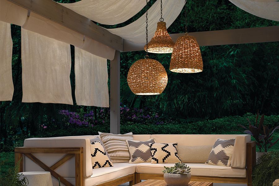A patio area with a couch and hanging lights