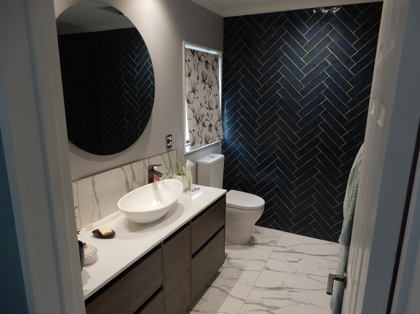 A bathroom with a sink , toilet and mirror