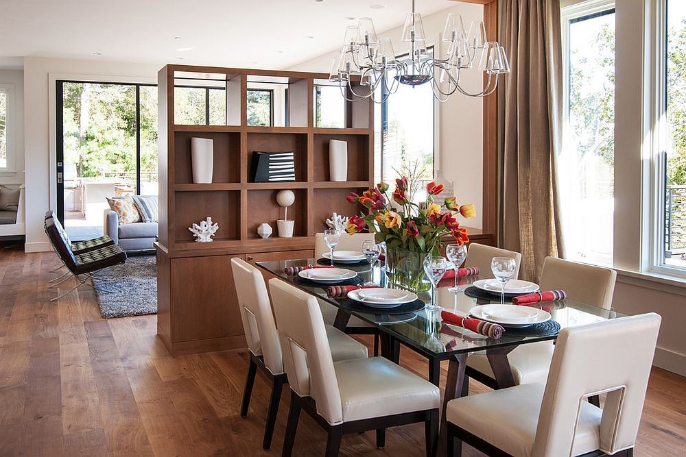 A dining room with a glass table and chairs