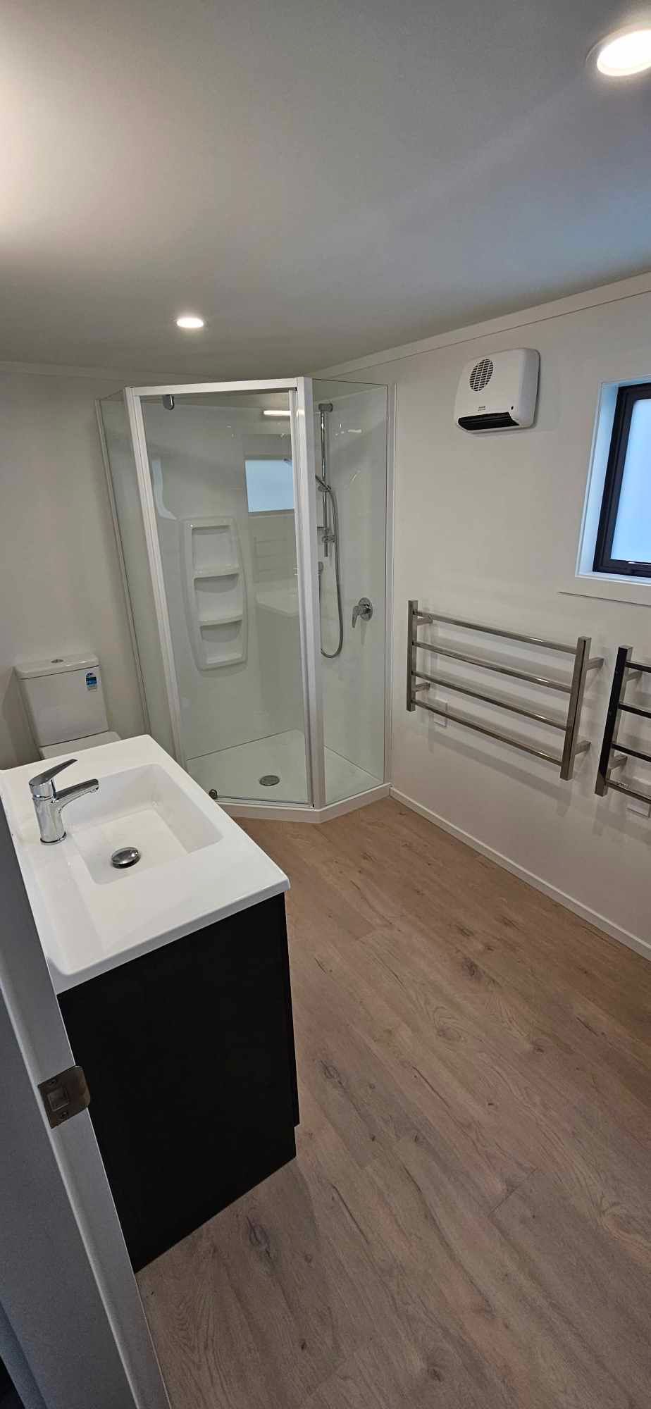 A bathroom with a sink , toilet and shower.