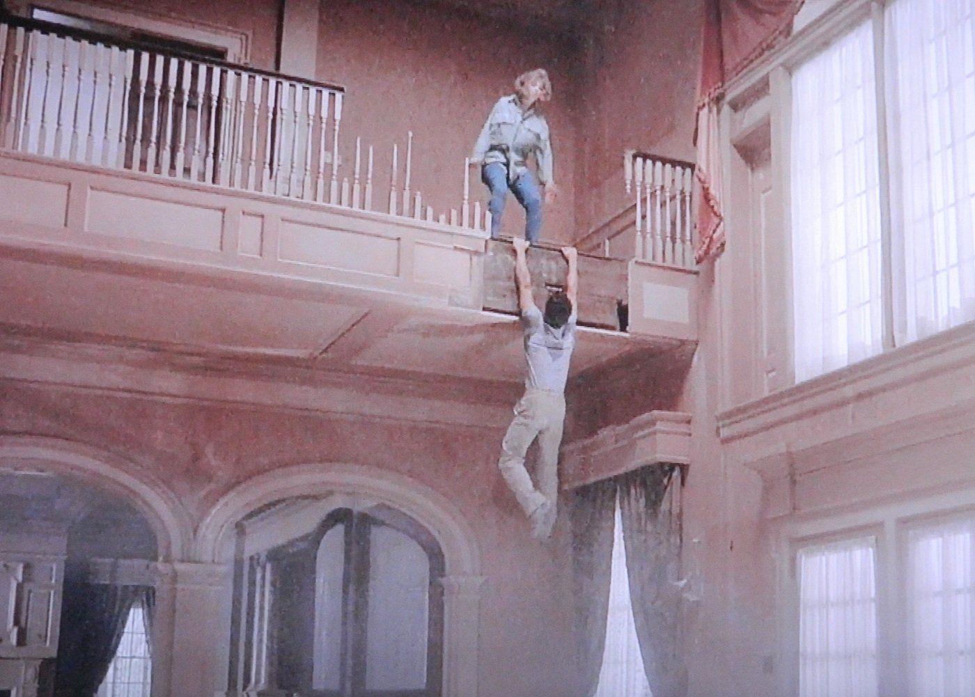 A man and a woman are hanging from the ceiling of a building.