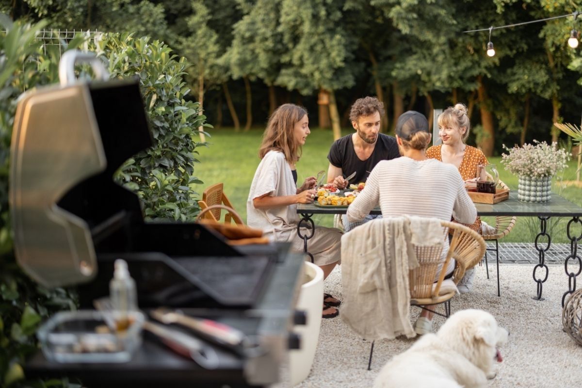 A group of people are sitting at a table with a dog.