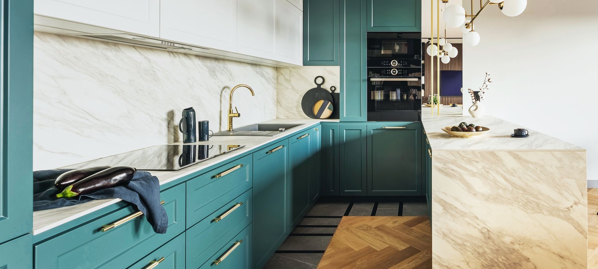 A kitchen with blue cabinets and a marble counter top.