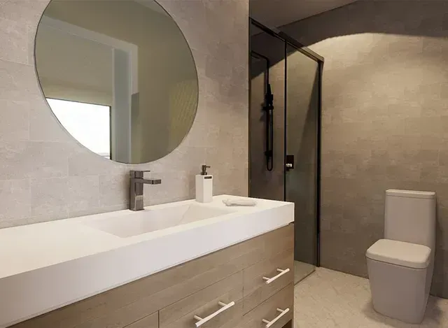 A bathroom with a sink , toilet and shower.