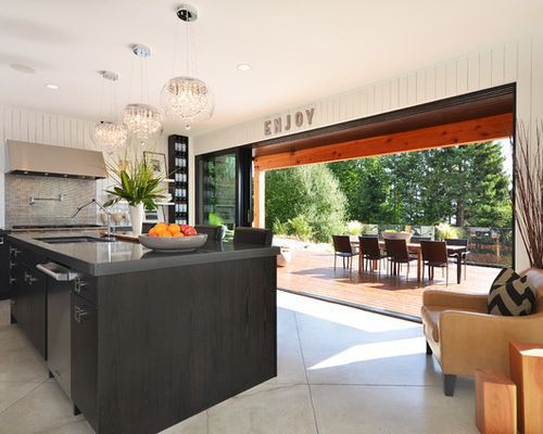 A kitchen with a large island and a sign that says enjoy