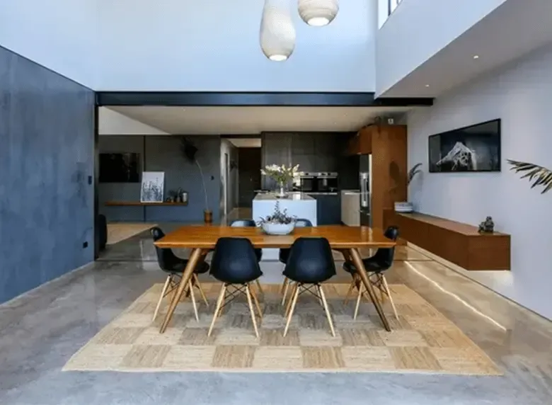 A dining room with a table and chairs in it