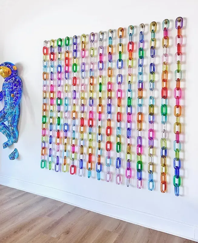 A wall with a bunch of colorful chains on it