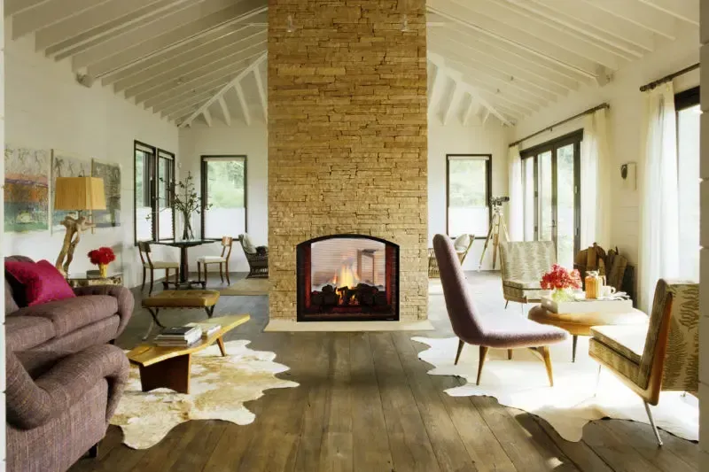 There is a fireplace in the middle of the living room.