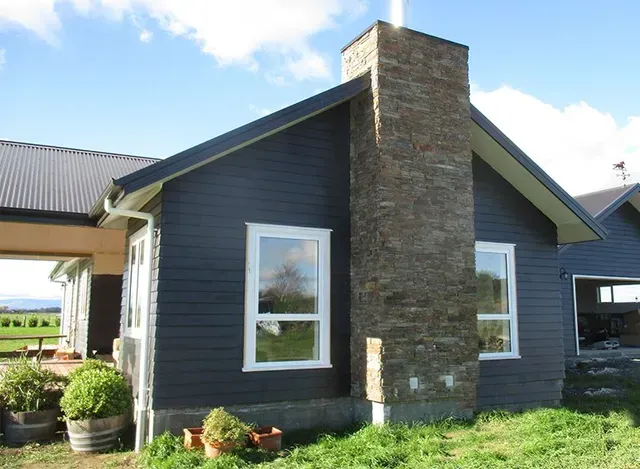 A house with a chimney on the side of it