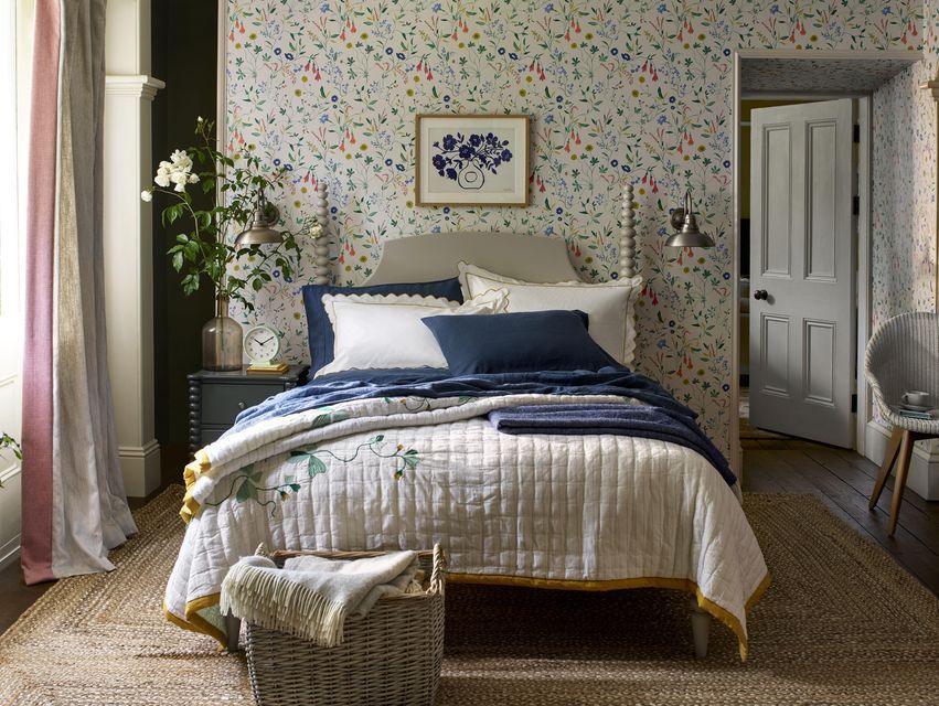 A bedroom with a bed and a picture on the wall.