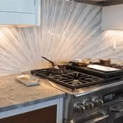 A stove top oven is sitting on top of a counter in a kitchen.