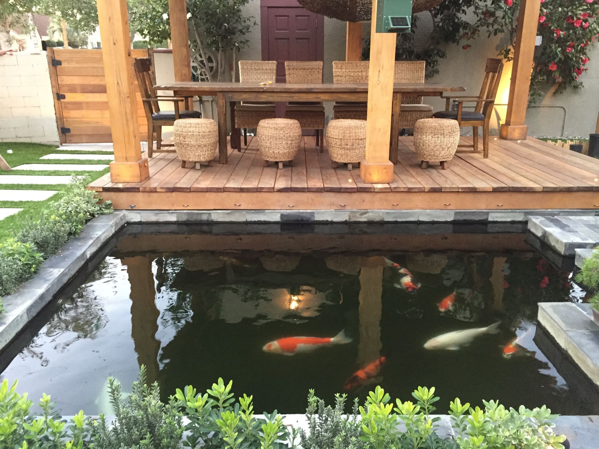 A pond with a table and chairs in the background